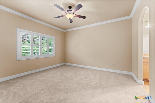 spare room with light carpet, baseboards, ornamental molding, and ceiling fan