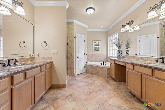 bathroom featuring a sink, a bath, two vanities, and crown molding