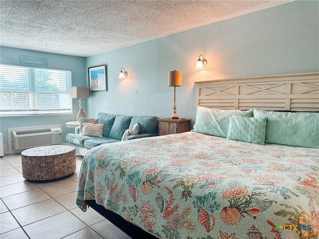 407 Beach Ave Unit 111, Port Aransas, TX 78373 - tiled bedroom featuring a textured ceiling and a wall mounted AC