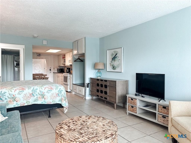 407 Beach Ave Unit 111, Port Aransas, TX 78373 - bedroom with light tile patterned floors and a textured ceiling