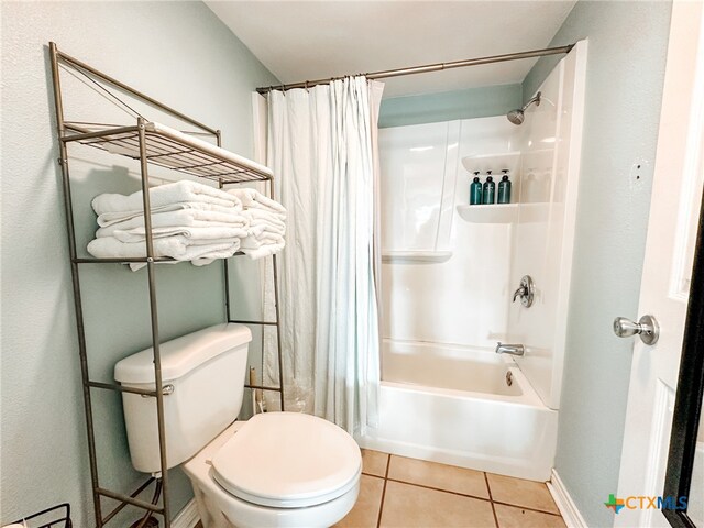 bathroom featuring toilet, shower / bath combo, and tile patterned flooring