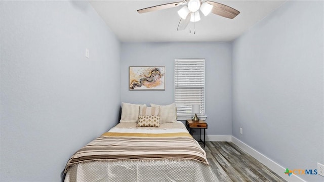 bedroom with ceiling fan and wood-type flooring