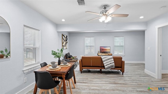 dining room featuring ceiling fan, a healthy amount of sunlight, and light hardwood / wood-style floors