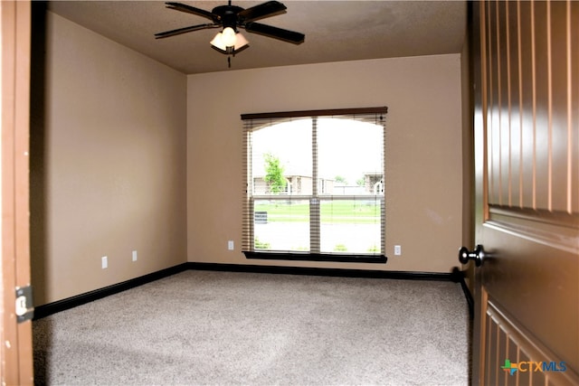 empty room with ceiling fan and carpet floors