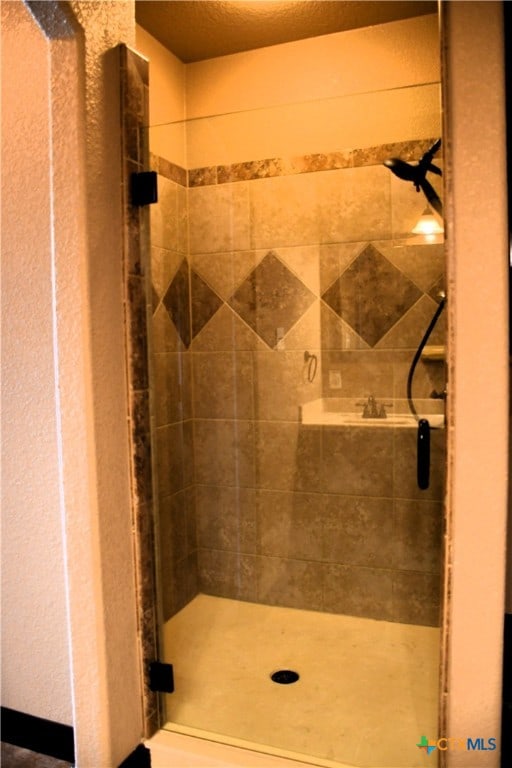 bathroom with tiled shower