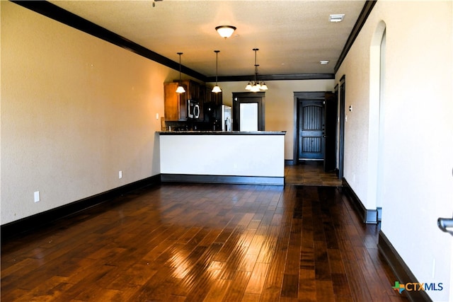 interior space with crown molding, dark hardwood / wood-style floors, and a notable chandelier