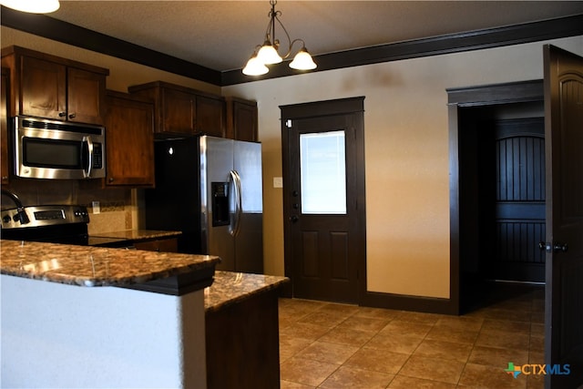 kitchen featuring backsplash, stainless steel appliances, crown molding, decorative light fixtures, and stone countertops