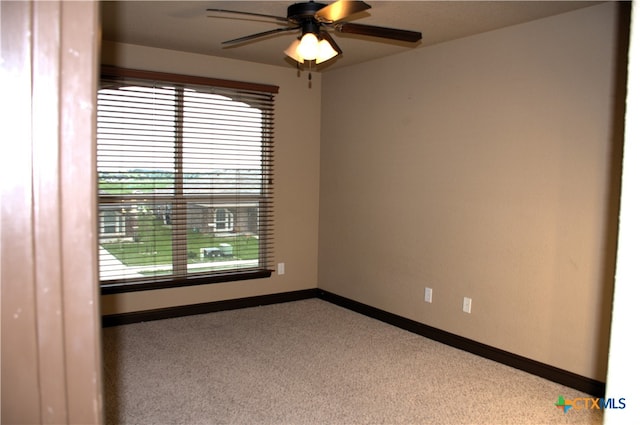 spare room featuring carpet and ceiling fan