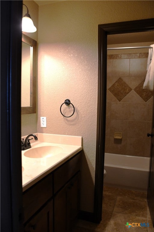 full bathroom featuring vanity, toilet, and tiled shower / bath combo