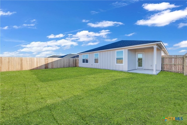 rear view of house with a patio area and a lawn