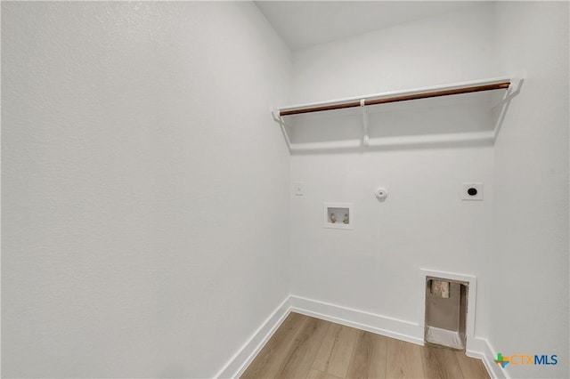 laundry area with hookup for a washing machine, hookup for a gas dryer, light hardwood / wood-style floors, and electric dryer hookup