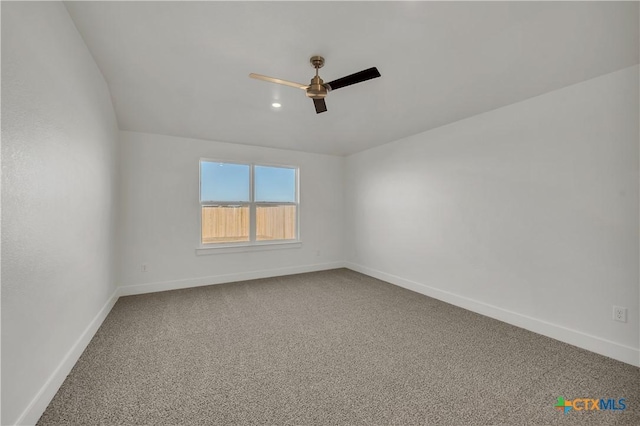 carpeted spare room featuring ceiling fan