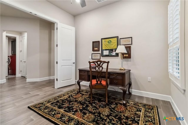 home office featuring ceiling fan and light hardwood / wood-style floors