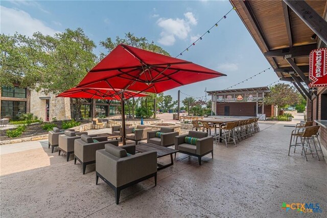 exterior space featuring a bar and an outdoor living space