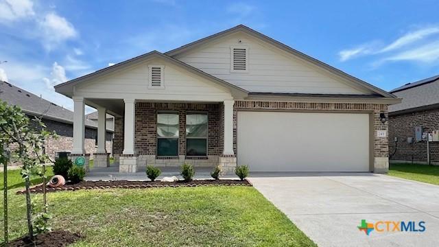 249 Bethann Dr, Temple, TX 76502 - ranch-style house featuring a porch, brick siding, an attached garage, concrete driveway, and a front yard