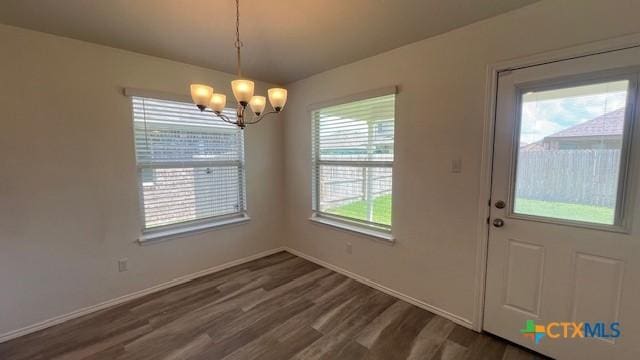 249 Bethann Dr, Temple, TX 76502 - unfurnished dining area with a chandelier and dark wood-style flooring