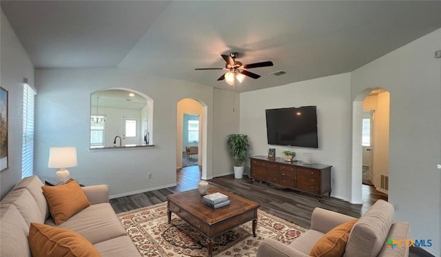 249 Bethann Dr, Temple, TX 76502 - living room with arched walkways, healthy amount of natural light, a ceiling fan, and dark wood-type flooring