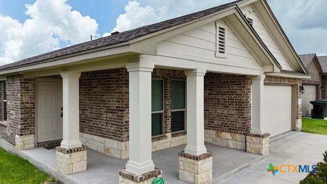 249 Bethann Dr, Temple, TX 76502 - view of home's exterior featuring brick siding, covered porch, and a garage