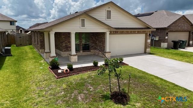 249 Bethann Dr, Temple, TX 76502 - view of front of property featuring brick siding, driveway, and a garage