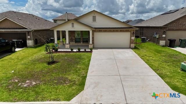 249 Bethann Dr, Temple, TX 76502 - view of front of home with an attached garage, concrete driveway, a front yard, and brick siding