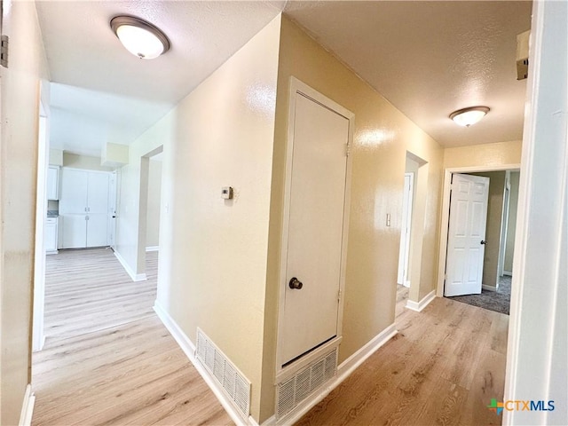 502 S 13th St, Copperas Cove, TX 76522 - corridor with light wood-style floors, baseboards, and a textured ceiling