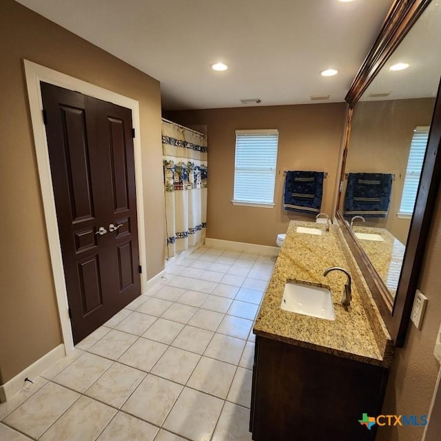 bathroom featuring tile patterned flooring, vanity, and toilet