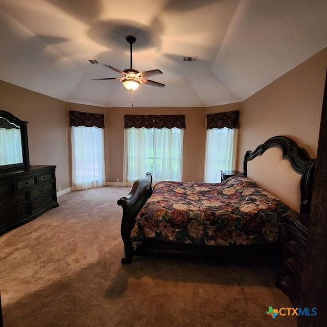 bedroom with ceiling fan, lofted ceiling, and carpet flooring