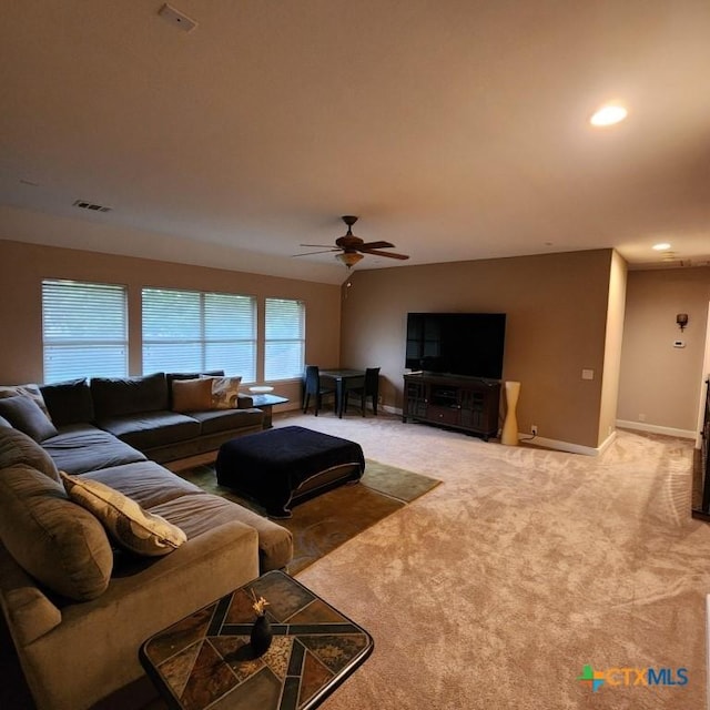 living room featuring light carpet and ceiling fan