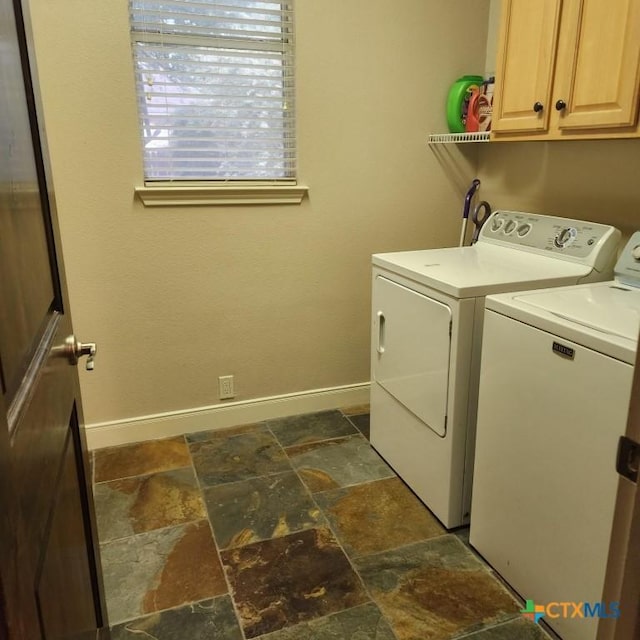 11710 Uplands Ridge Dr, Austin, TX 78738 - clothes washing area with washer and clothes dryer, cabinet space, stone tile floors, and baseboards