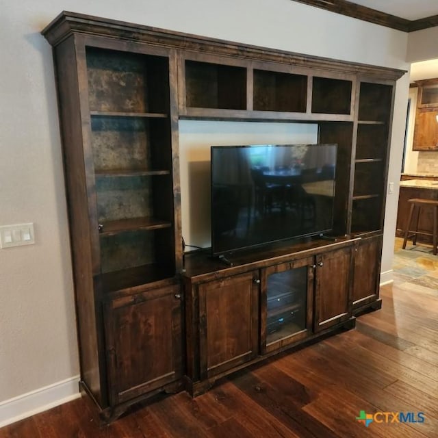 living room featuring ornamental molding and dark hardwood / wood-style floors