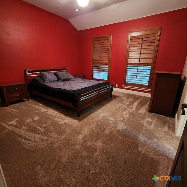 bedroom featuring lofted ceiling and carpet