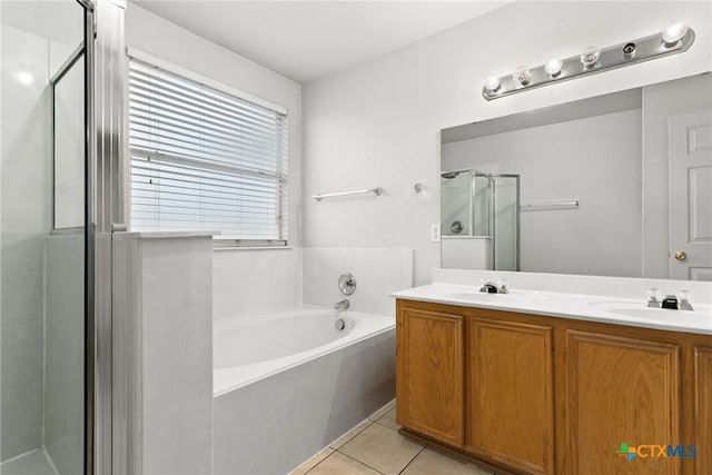 bathroom with tile patterned flooring, vanity, and plus walk in shower