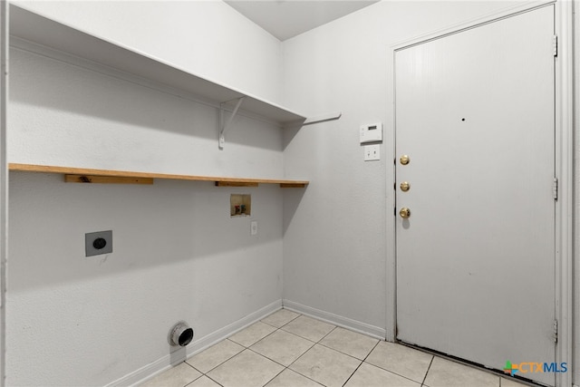 washroom with light tile patterned floors, hookup for a washing machine, electric dryer hookup, laundry area, and baseboards