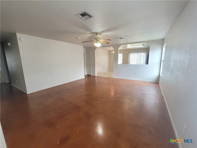 spare room featuring ceiling fan, concrete floors, and a textured ceiling