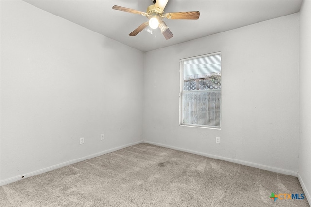 empty room with ceiling fan and light carpet