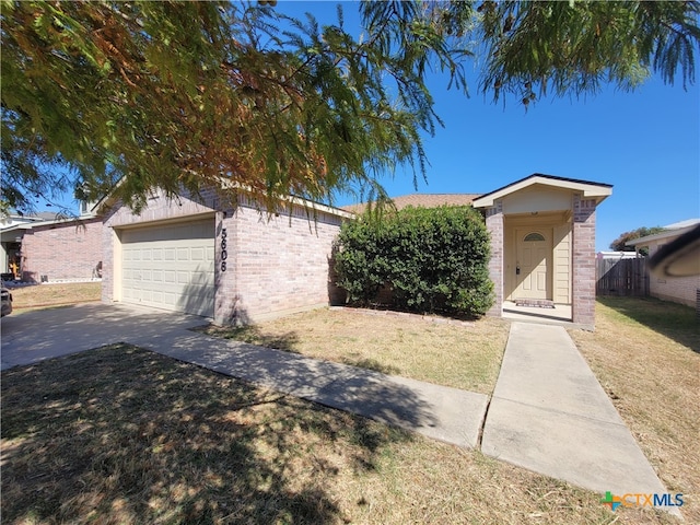 view of front of house featuring a front yard and a garage