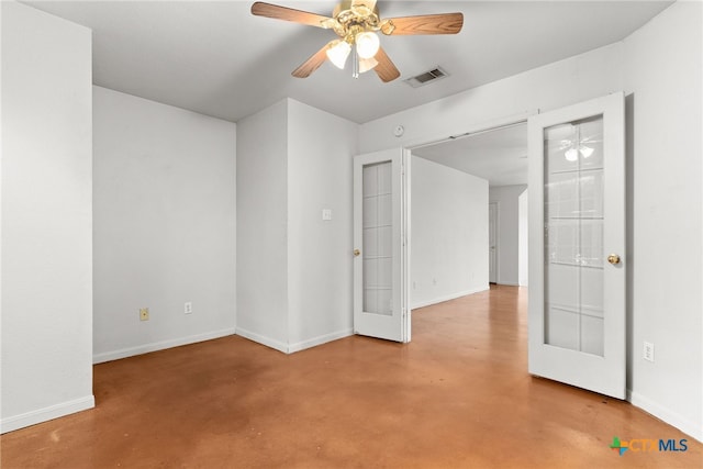 empty room featuring ceiling fan and french doors