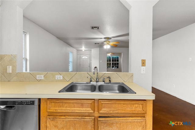 kitchen featuring decorative backsplash, stainless steel dishwasher, ceiling fan, sink, and wood-type flooring