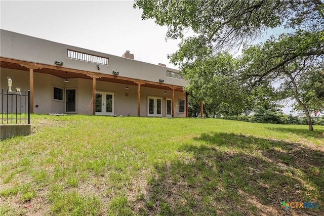 9776 Arroyo Dr, Belton, TX 76513 - rear view of house with french doors, a yard, and stucco siding