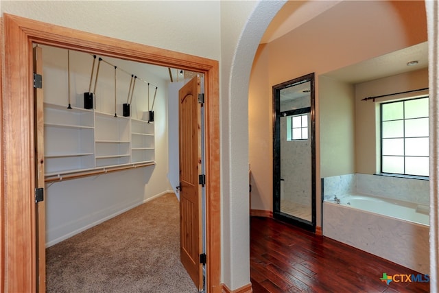 bathroom featuring a bath and hardwood / wood-style flooring