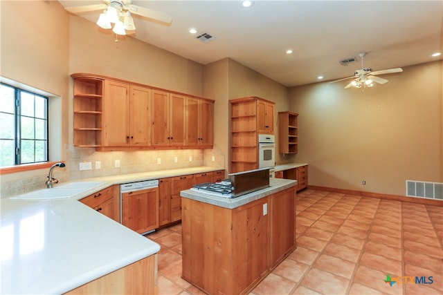 kitchen with sink, tasteful backsplash, ceiling fan, light tile patterned flooring, and white appliances