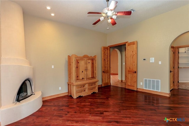 9776 Arroyo Dr, Belton, TX 76513 - unfurnished living room with arched walkways, wood finished floors, ceiling fan, baseboards, and recessed lighting