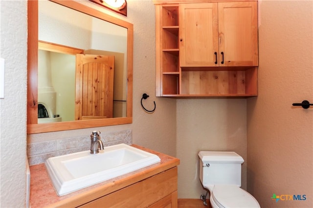 9776 Arroyo Dr, Belton, TX 76513 - half bathroom with a textured wall, toilet, and vanity