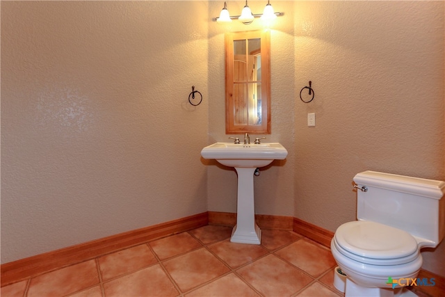 bathroom with toilet and tile patterned flooring