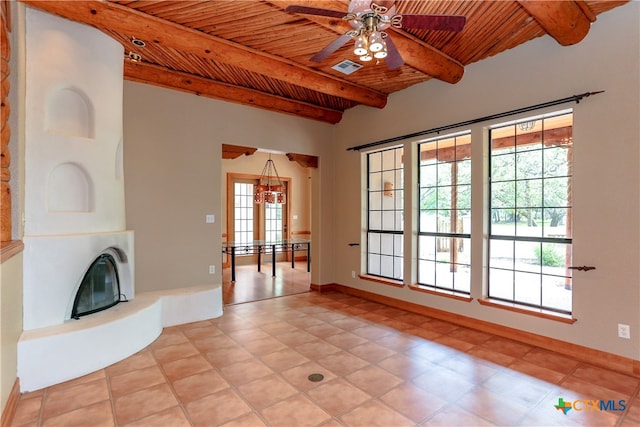 unfurnished living room featuring ceiling fan, wood ceiling, and beam ceiling