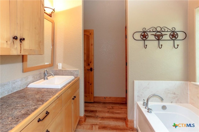 9776 Arroyo Dr, Belton, TX 76513 - full bath featuring wood finished floors, a garden tub, and vanity