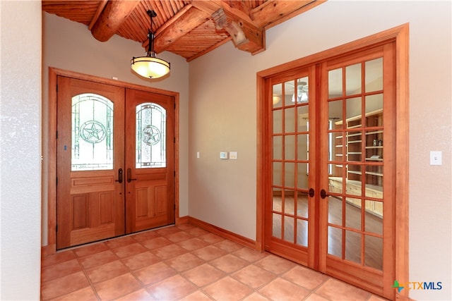 foyer with french doors, beam ceiling, and wood ceiling