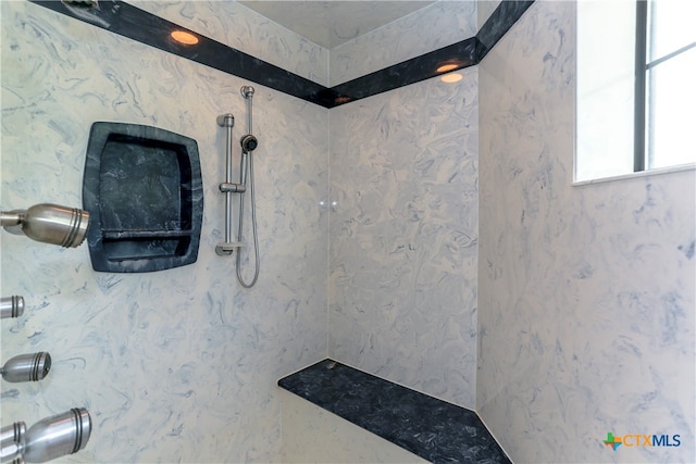 bathroom with a tile shower