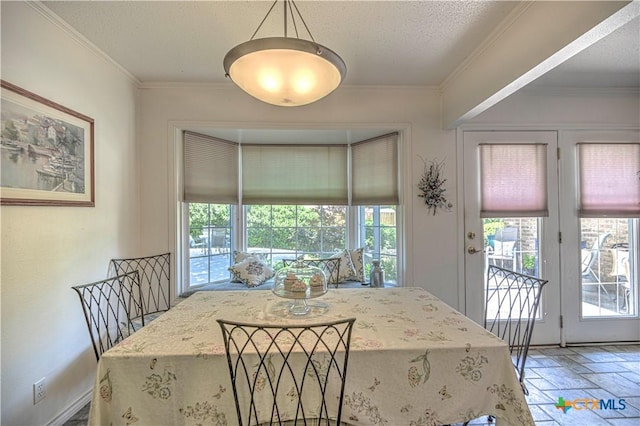 4701 Hickory Rd, Temple, TX 76502 - dining area with ornamental molding, a textured ceiling, and light stone finish flooring