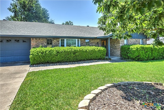 4701 Hickory Rd, Temple, TX 76502 - single story home featuring brick siding, an attached garage, a front yard, and concrete driveway